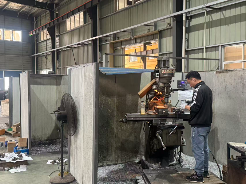 Engineer operating CNC machine on factory floor